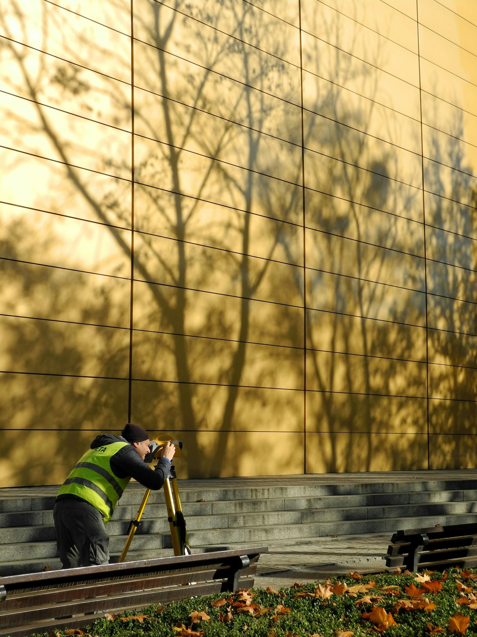 Surveyor inspecting building exterior.