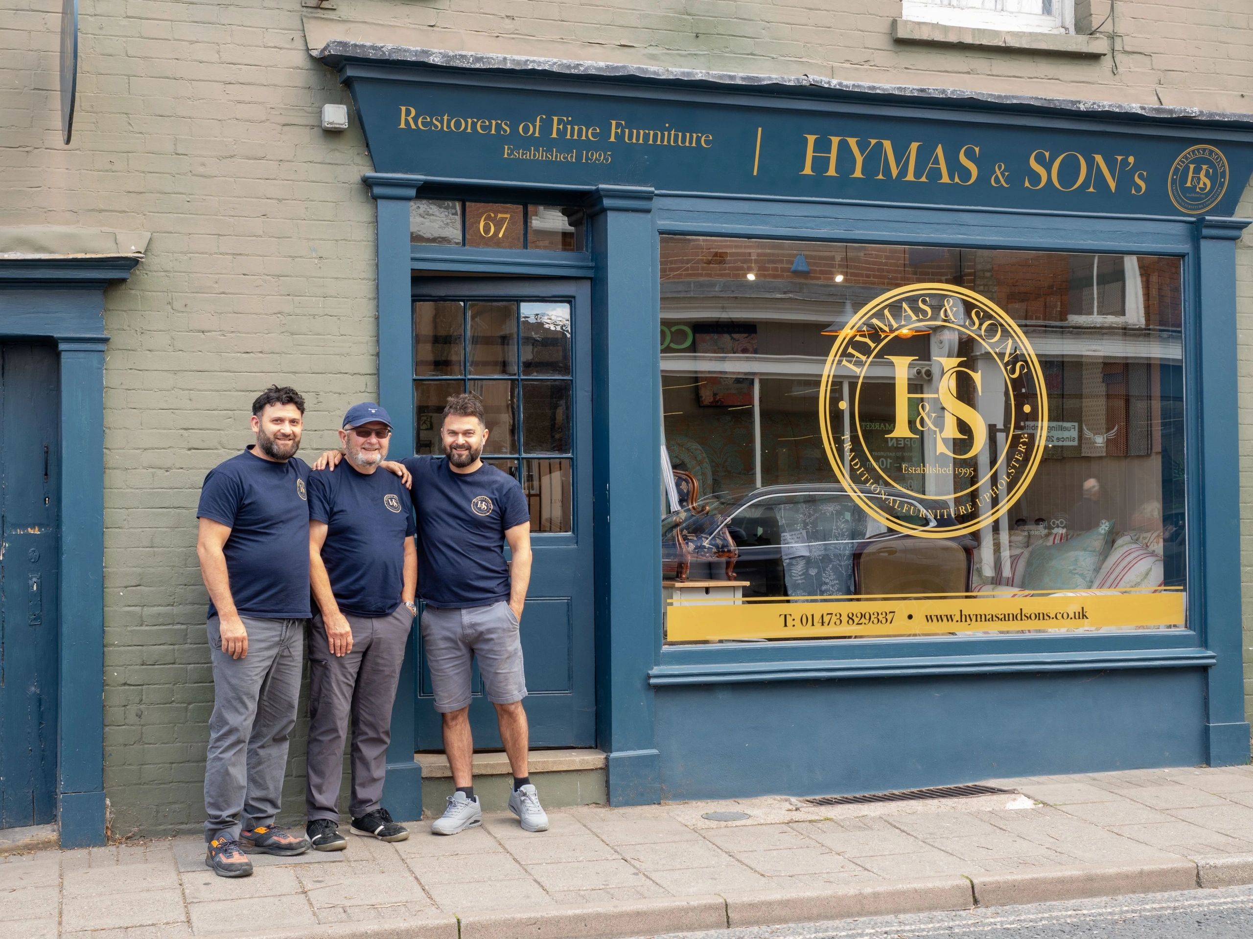 Outside 67 High Street, Hadleigh — the Hymas & Sons workshop with the family standing in front of the door