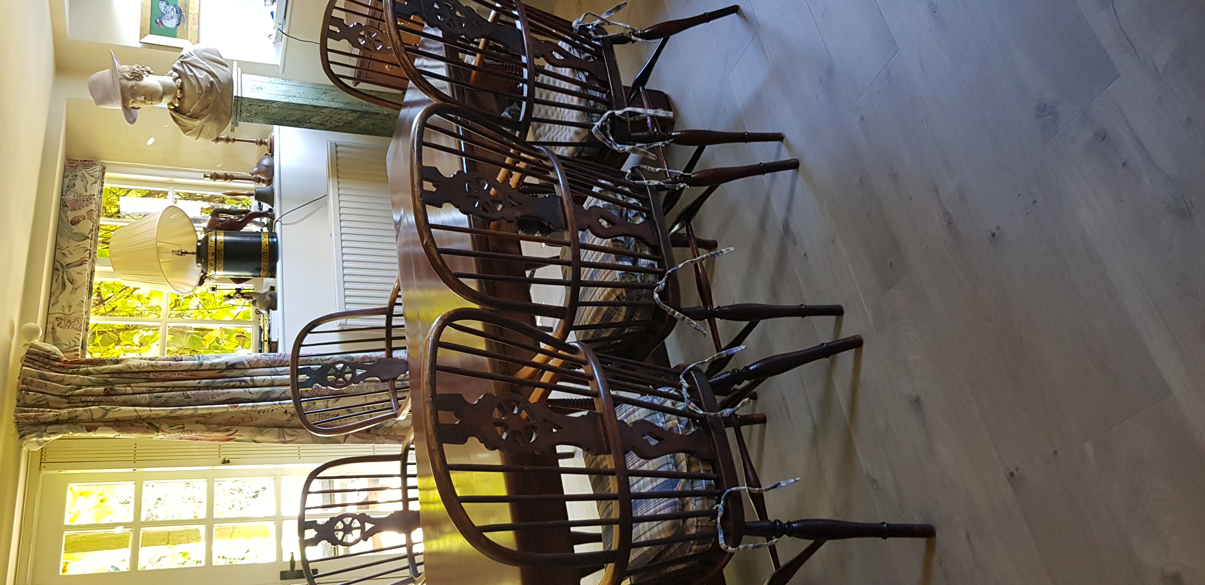 A set of antique Windsor chairs around a polished dining table — restored by JD Furniture Restoration
